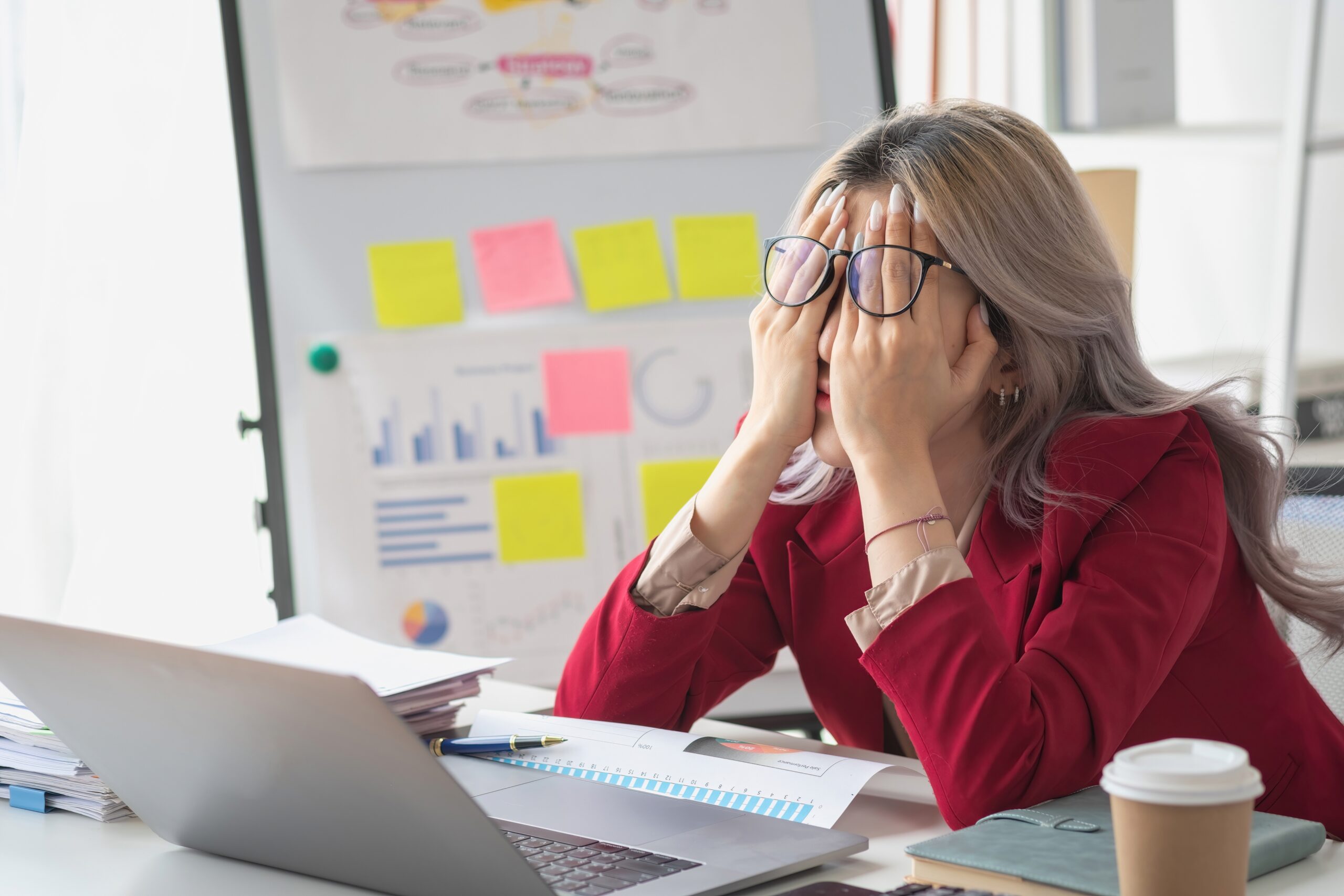 Corporate woman feeling stressed and overwhelmed at work
