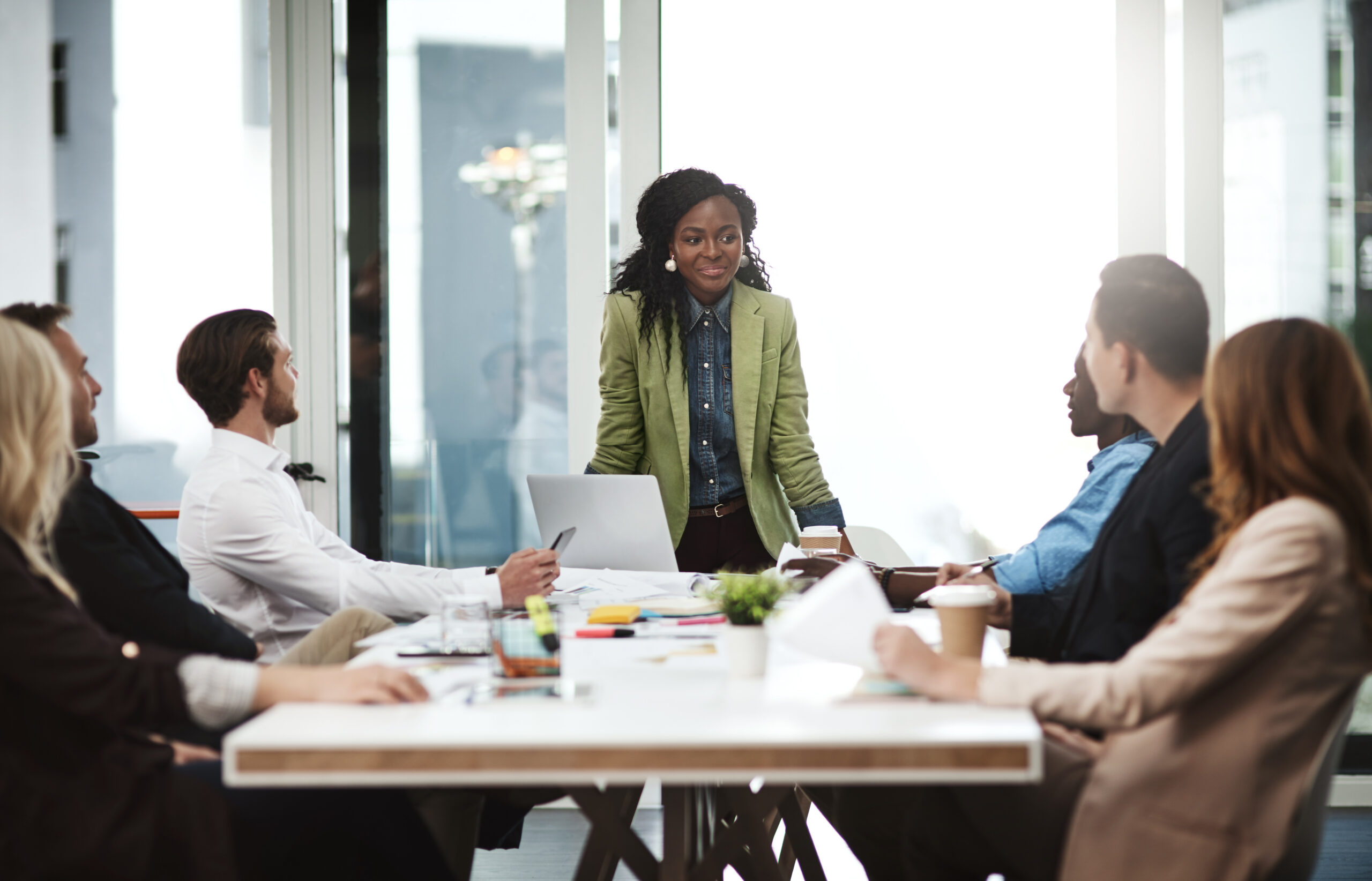 A manager leading a meeting at Take Off Enterprises.